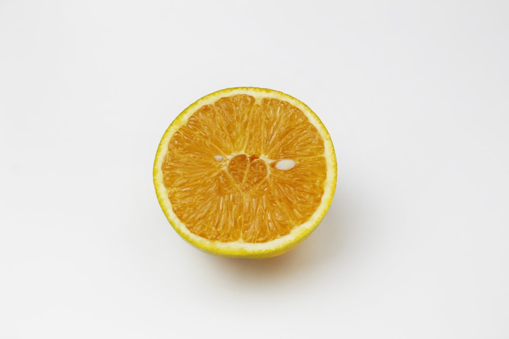 sliced orange fruit on white surface