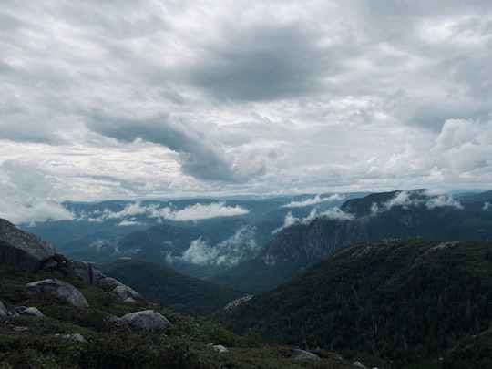 green mountains under white clouds during daytime in Mont du Lac des Cygnes Canada