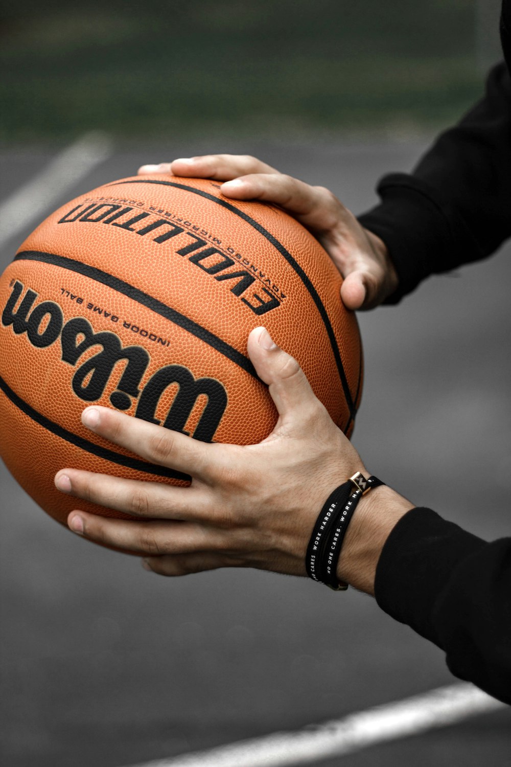 person holding brown basketball ball