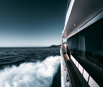 white and black ship on sea under blue sky during daytime