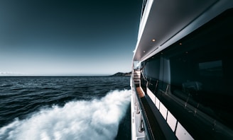 white and black ship on sea under blue sky during daytime