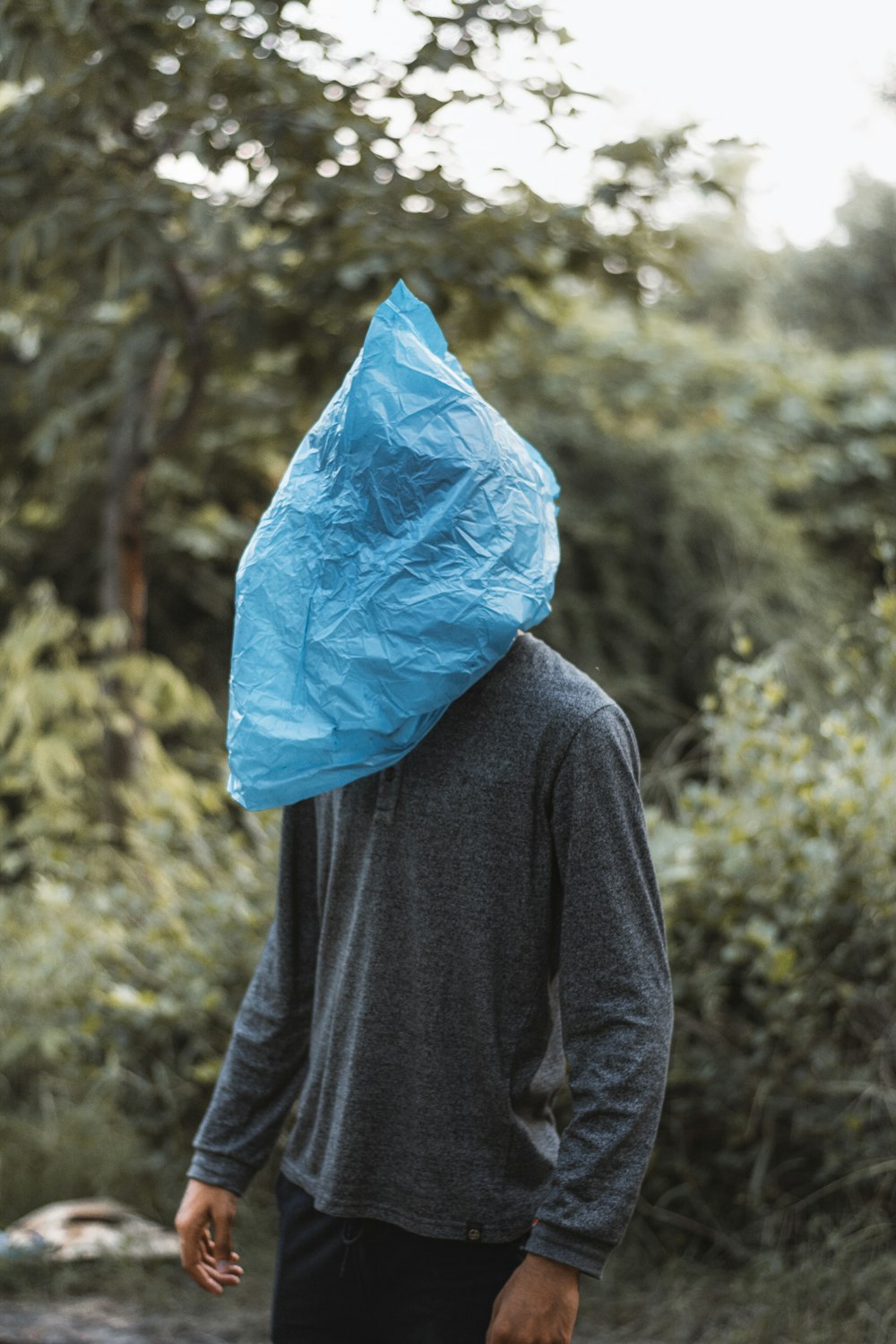 person in blue plastic bag