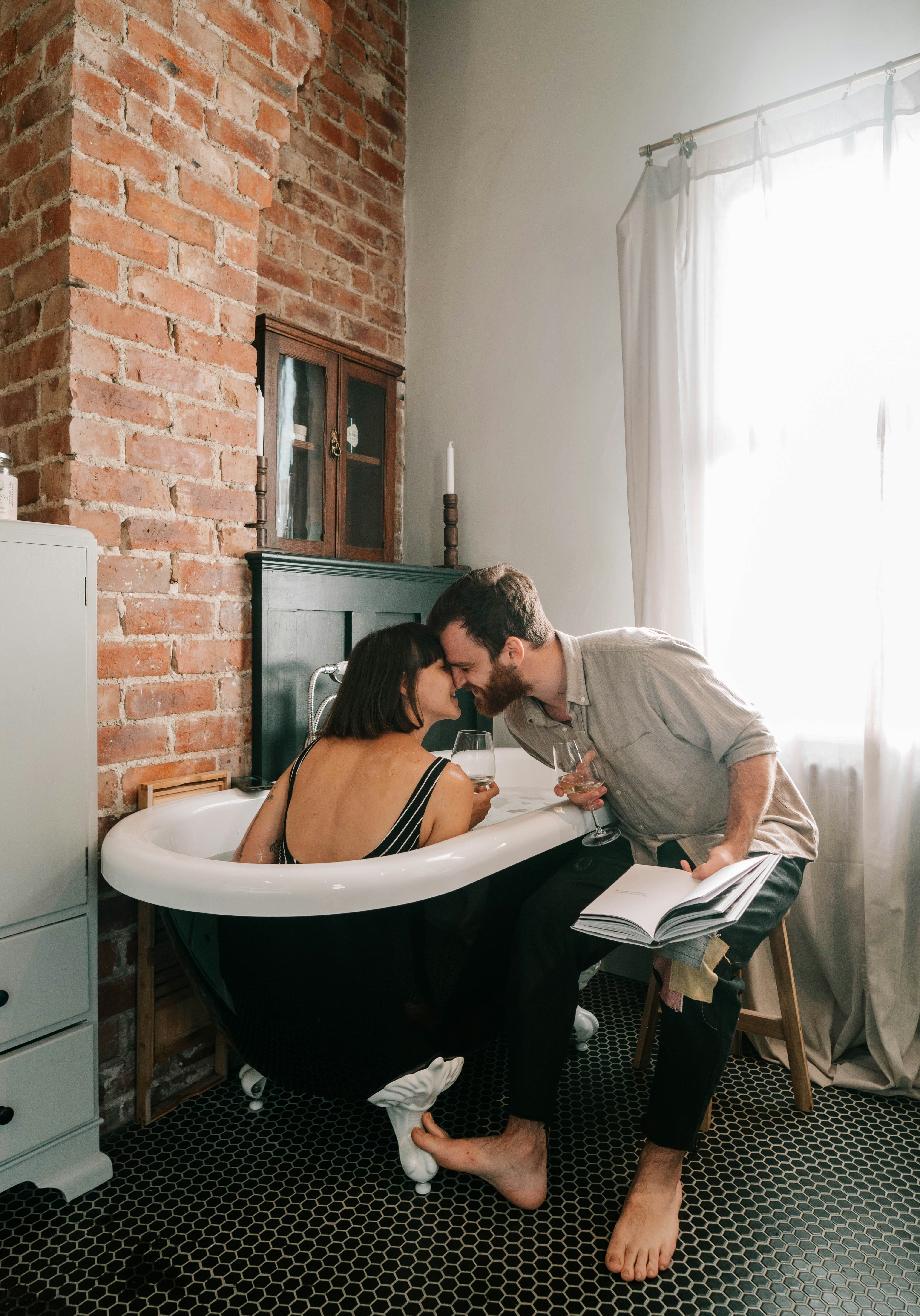 Man And Woman Sitting On Bathtub Reading Book Photo Free Human Image On Unsplash