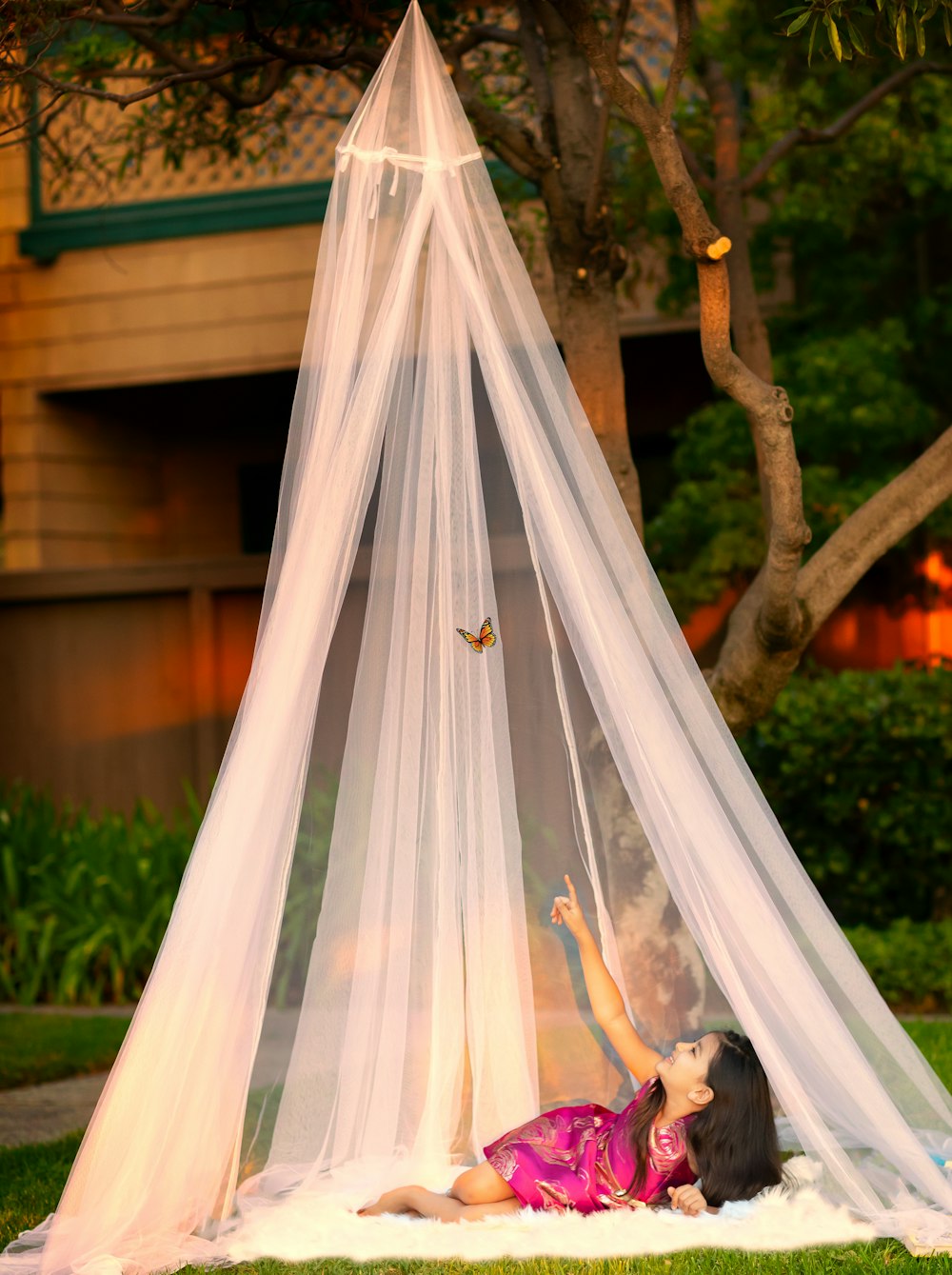 baby in white and pink tent