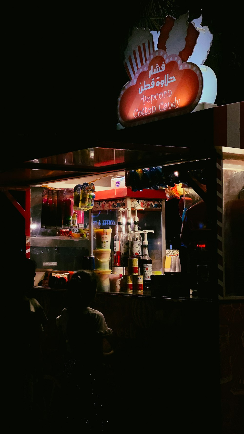 people sitting on chair near store during nighttime