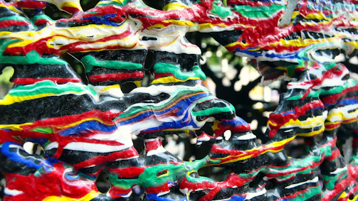 A mixed media piece combining sculpture and paint in harmony.