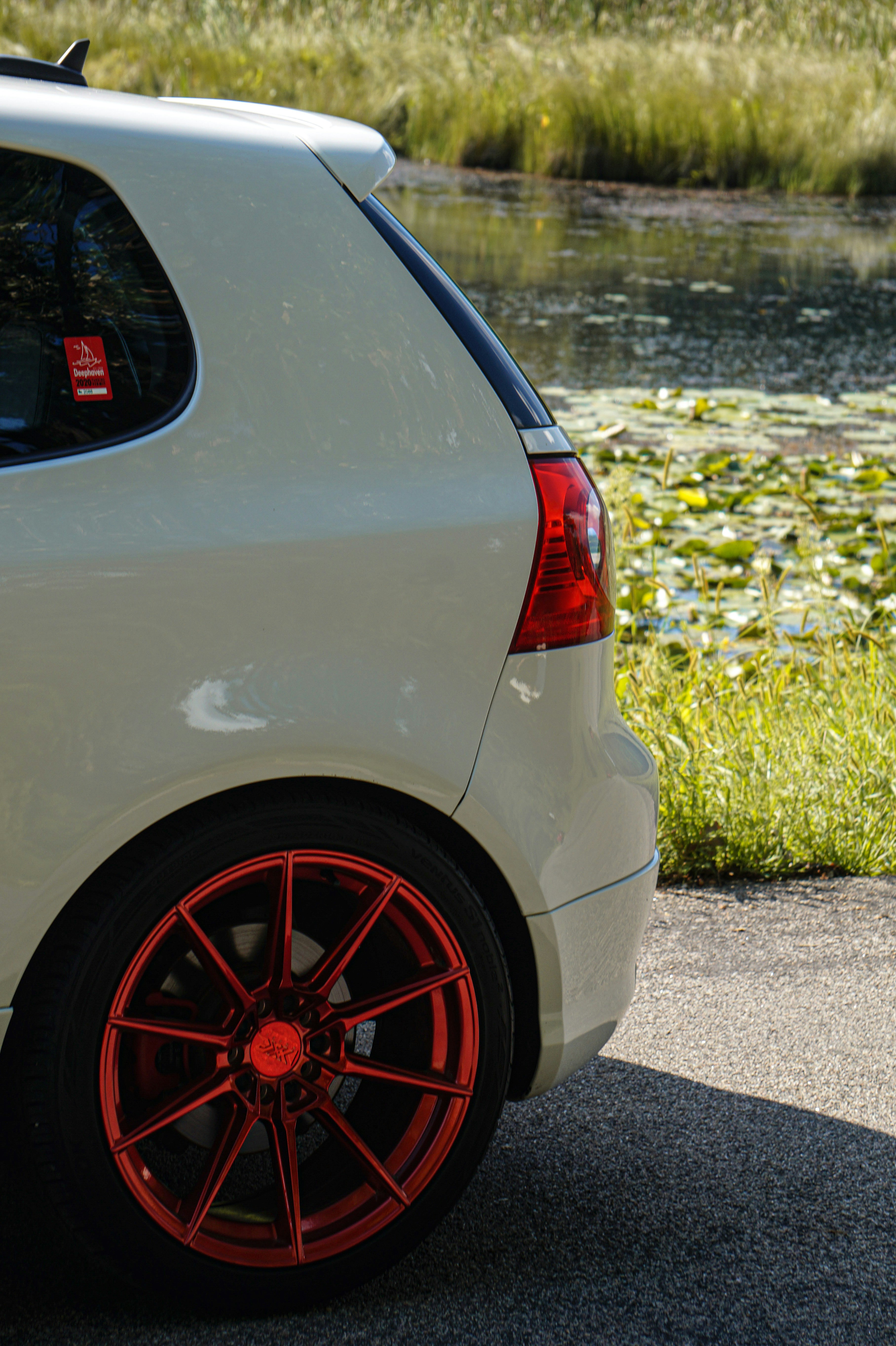 white car on gray asphalt road during daytime