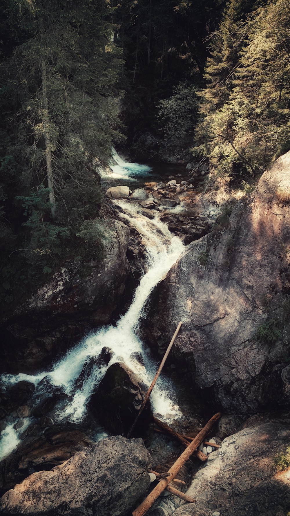 river between brown rocky mountain during daytime