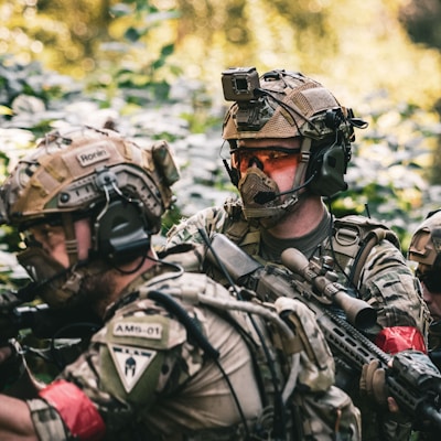 man in black and gray camouflage uniform wearing black helmet and black helmet