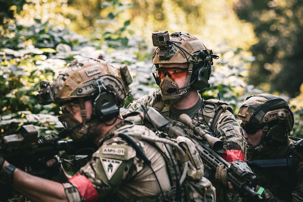 man in black and gray camouflage uniform wearing black helmet and black helmet