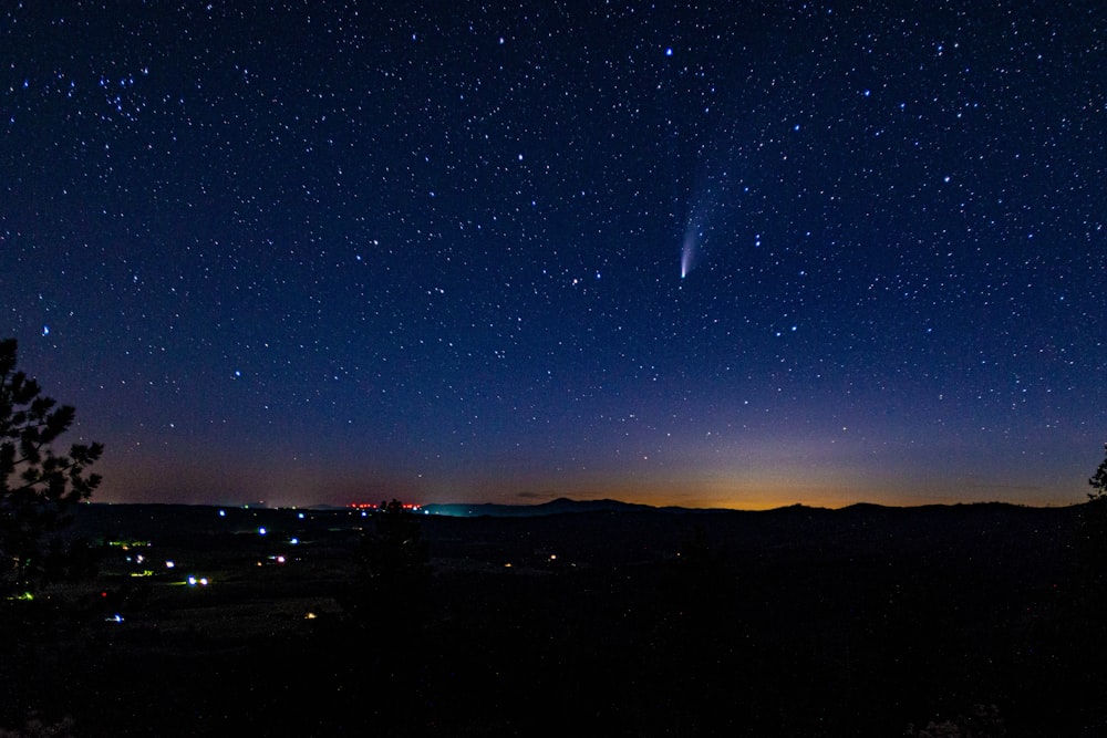 silhouette of mountain under starry night