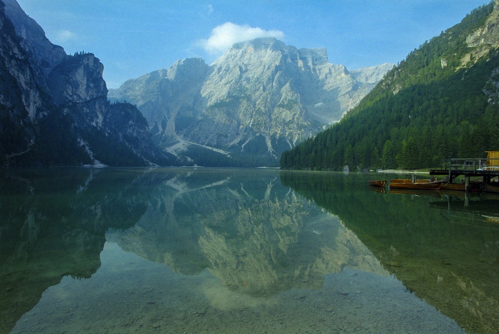 lake near mountain under blue sky during daytime