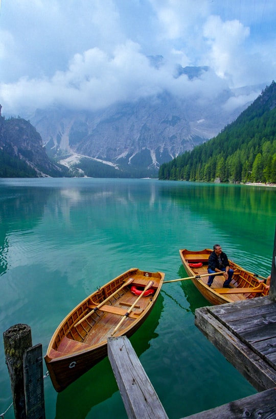 brown wooden boat on lake during daytime in Parco naturale di Fanes-Sennes-Braies Italy