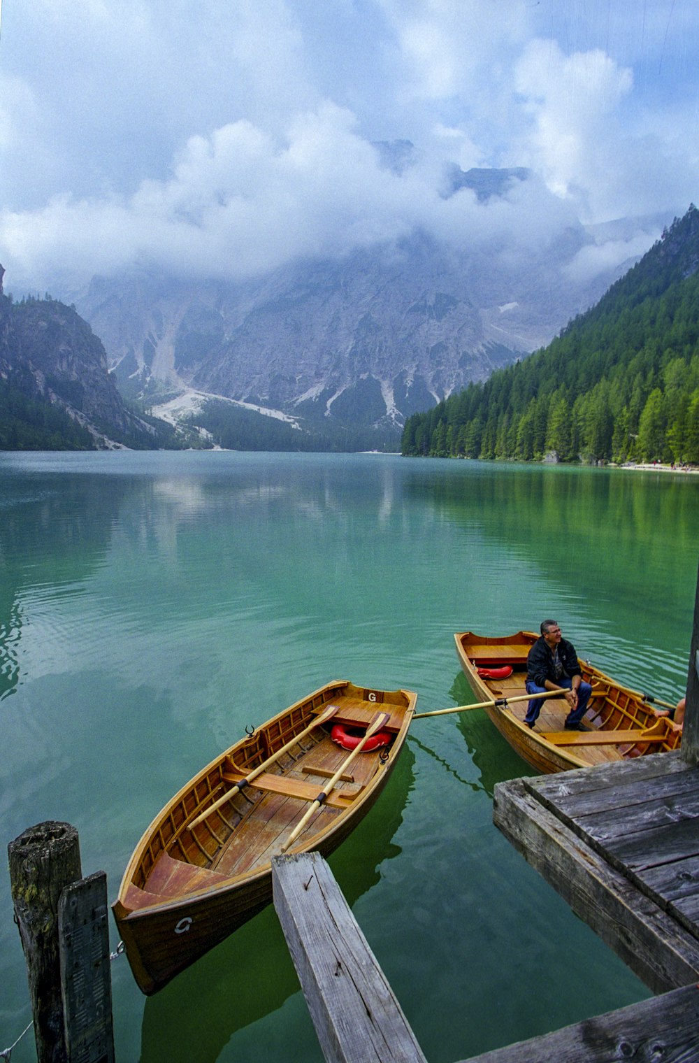 brown wooden boat on lake during daytime