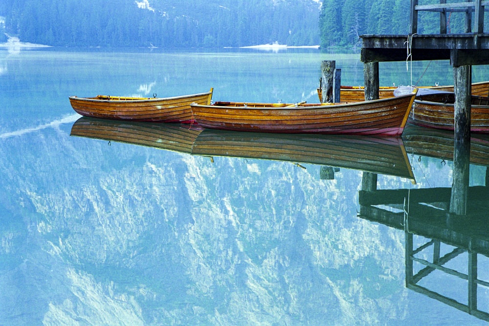 brown wooden boat on body of water during daytime