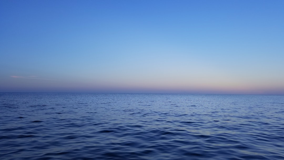 blue ocean water under blue sky during daytime