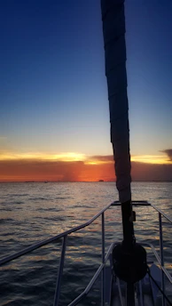 A vibrant sunrise over the calm waters of southwest Florida, with a fishing boat ready for a day of adventure.