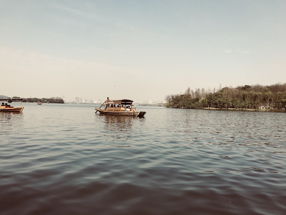 brown boat on body of water during daytime