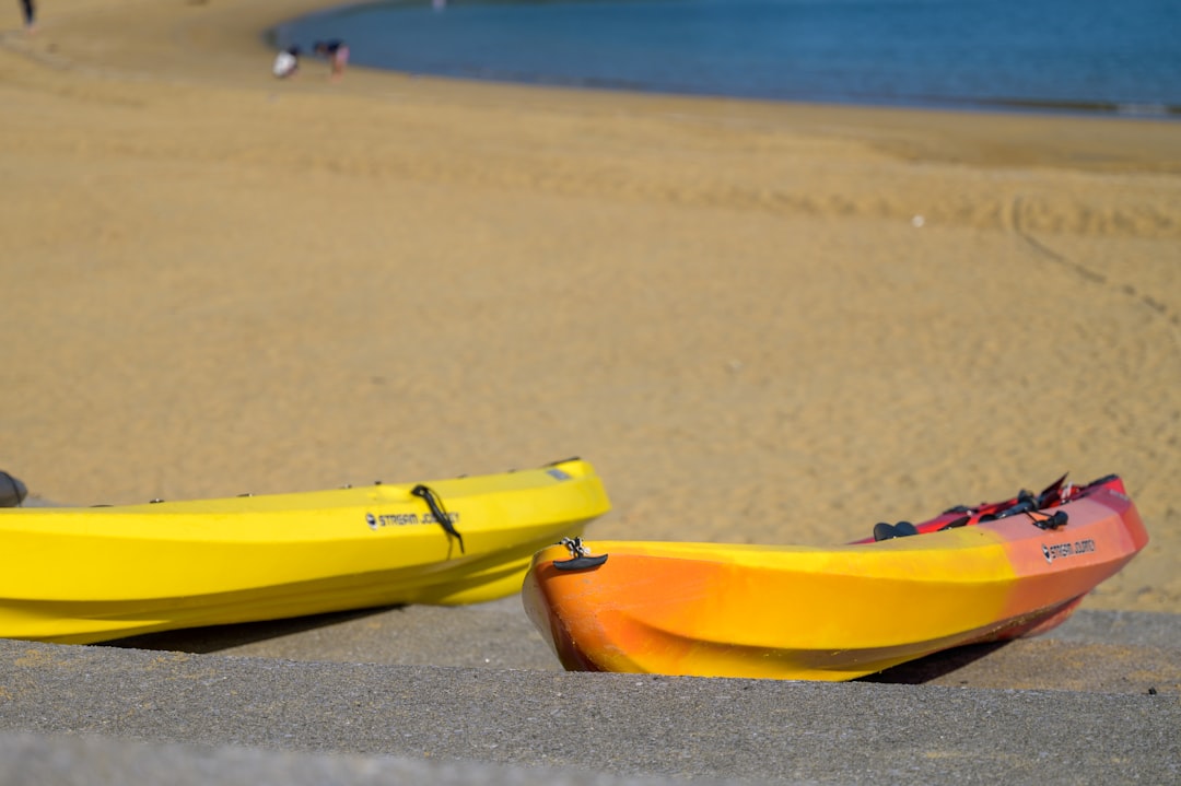 yellow kayak on brown sand beach during daytime