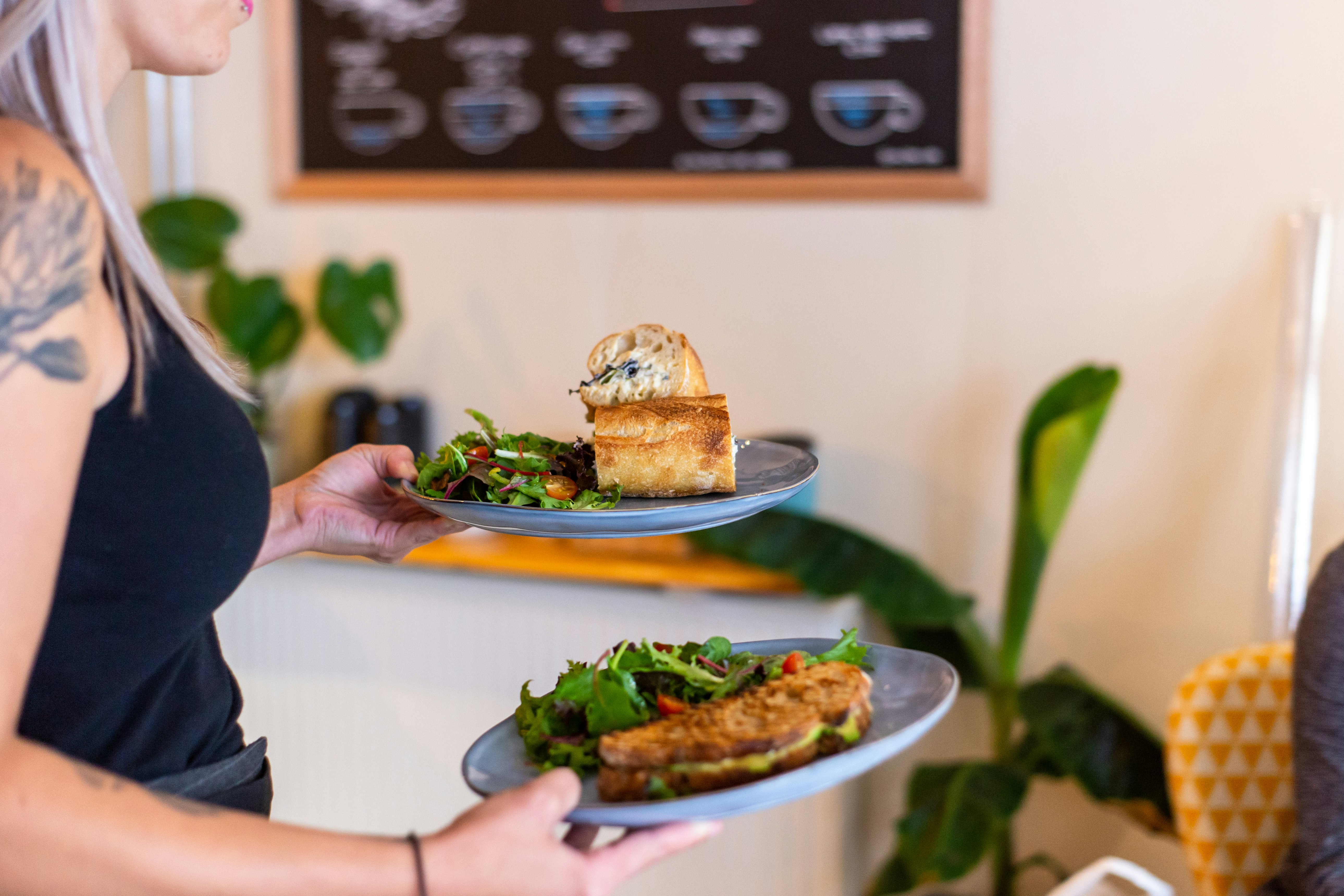 person in black t-shirt holding bread