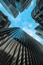 low angle photography of high rise buildings under blue sky during daytime