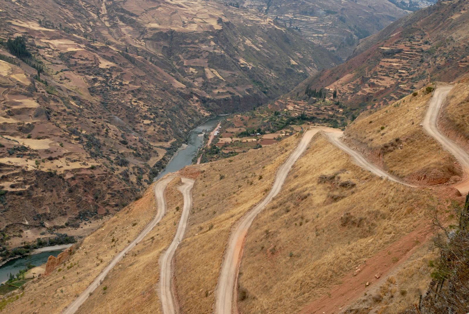 A winding road cut into a steep valley near Llata, Peru