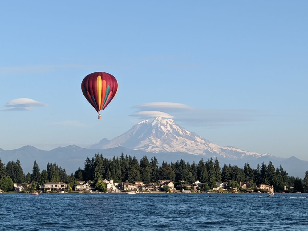 hot air balloon floating over the lake