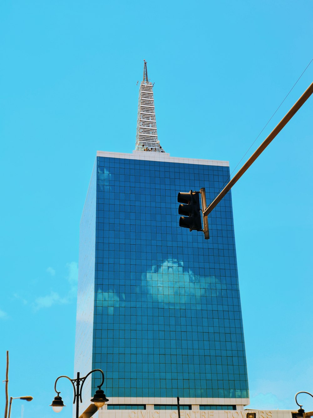 black traffic light near black and white building during daytime