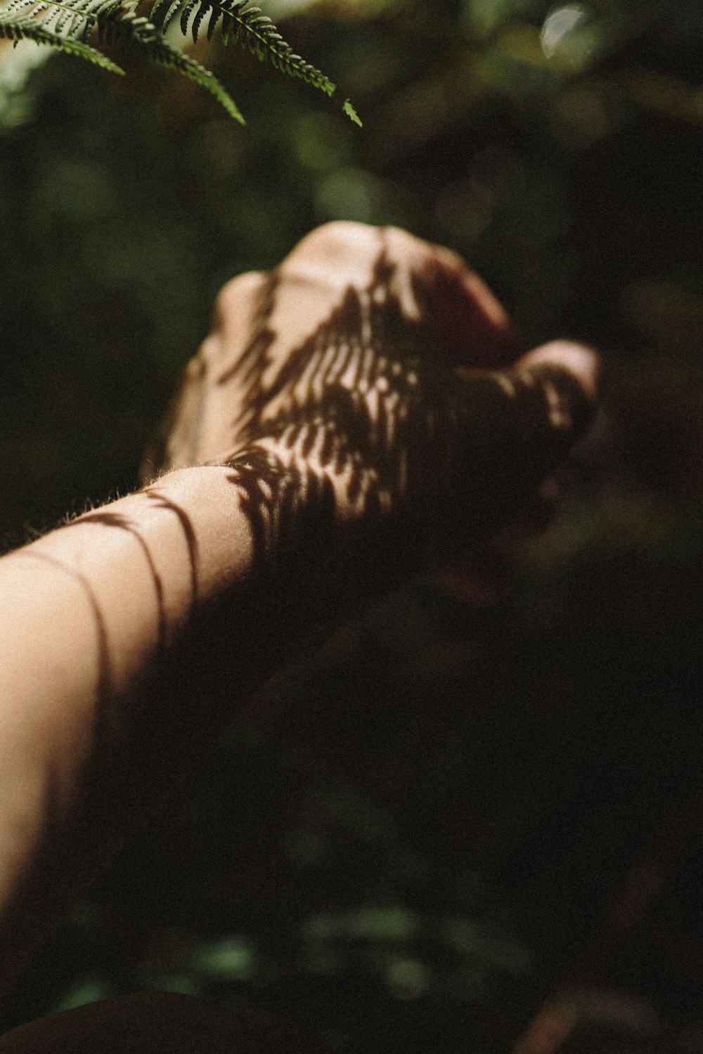 persons hand with black tattoo