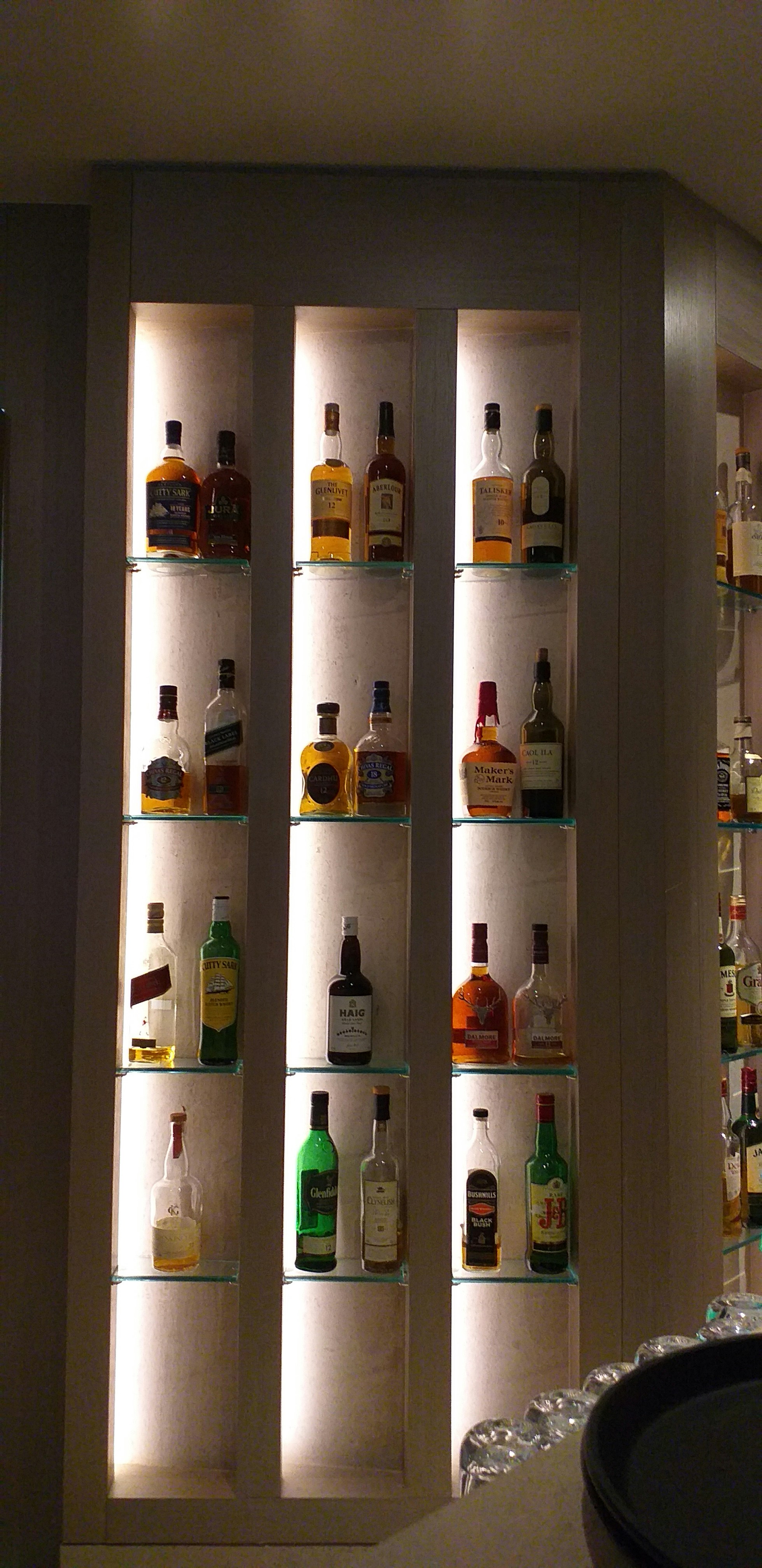 bottles on white wooden shelf