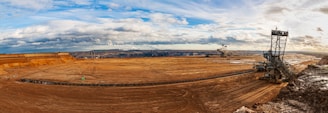 brown field under blue sky during daytime