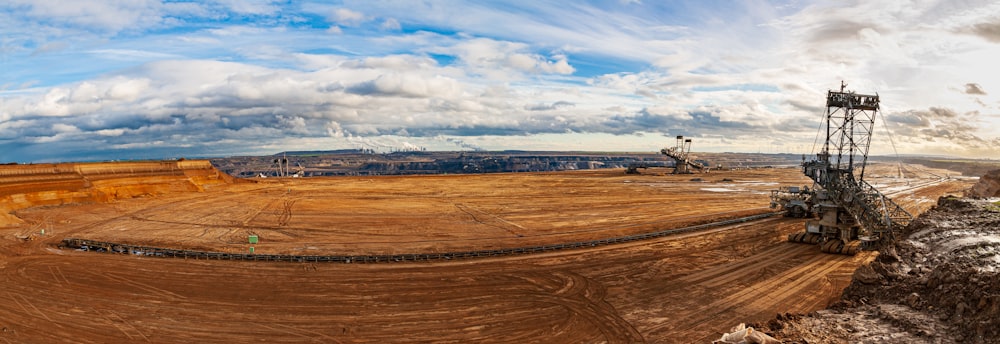 brown field under blue sky during daytime