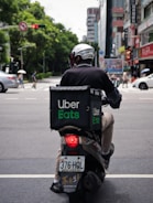 man in black jacket riding motorcycle on road during daytime