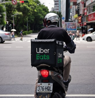 man in black jacket riding motorcycle on road during daytime