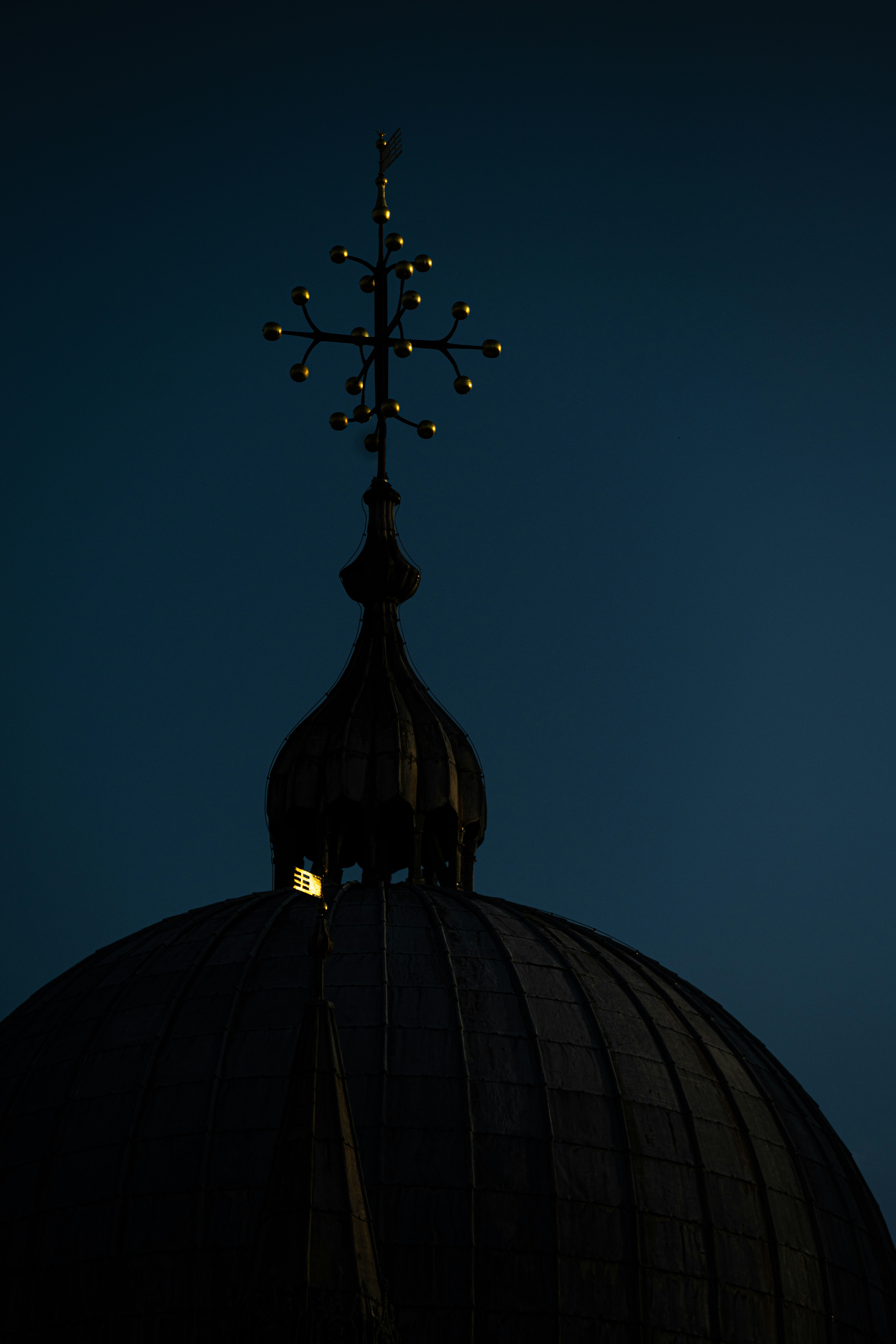 black cross on top of dome building