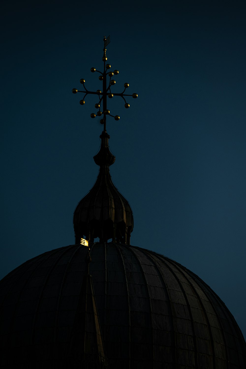 black cross on top of dome building