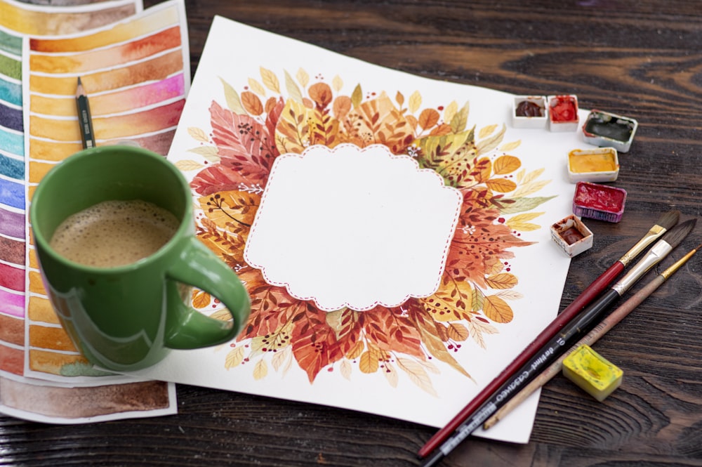 green ceramic mug on brown wooden table