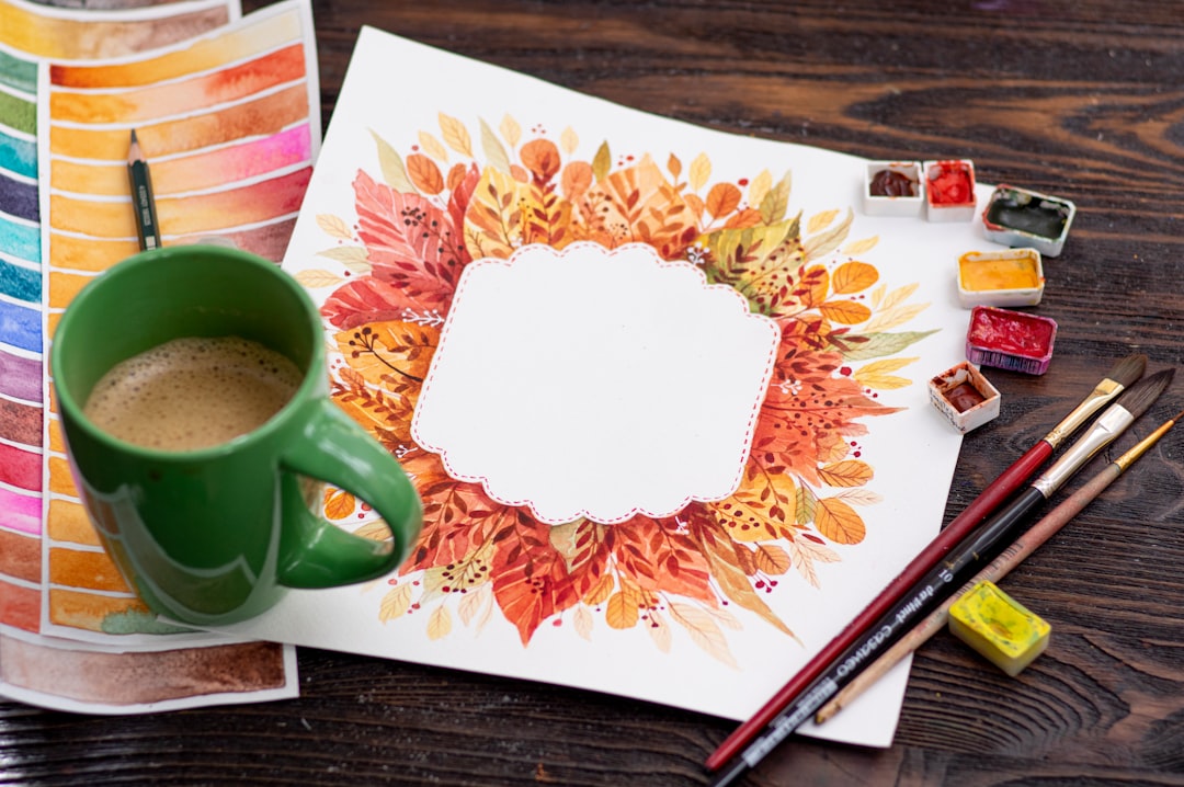 green ceramic mug on brown wooden table