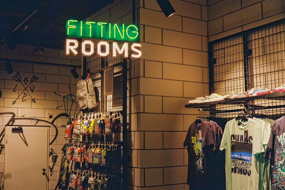 a store with a neon sign that says fitting rooms