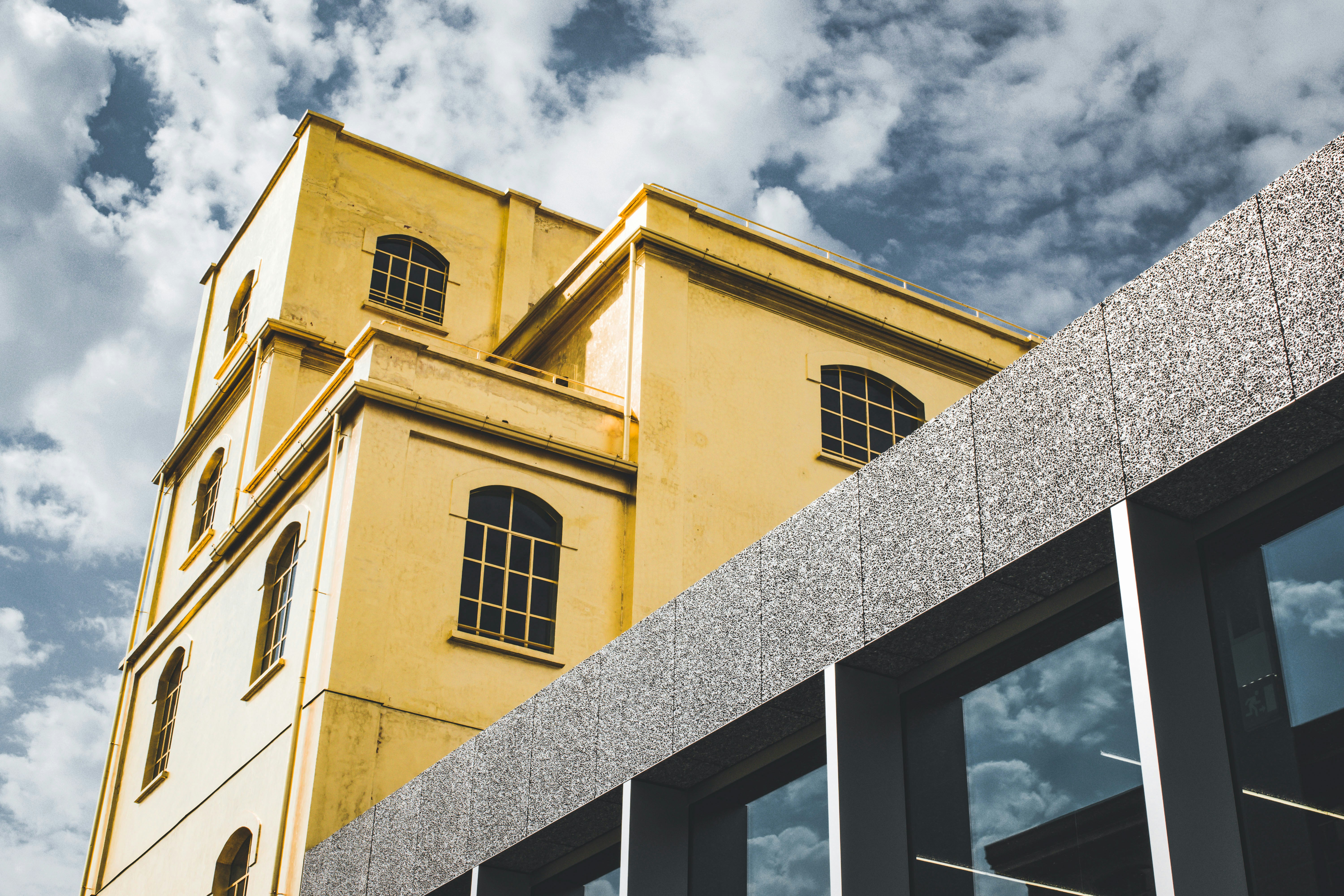 yellow concrete building under cloudy sky during daytime