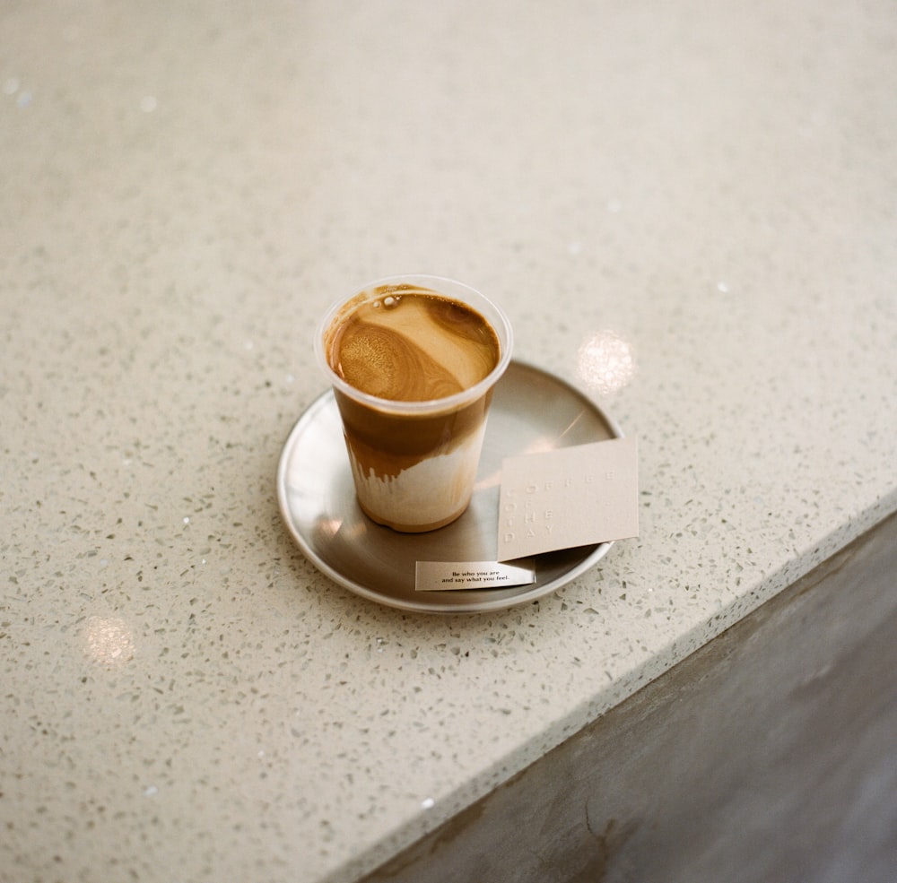 white ceramic mug on white ceramic saucer