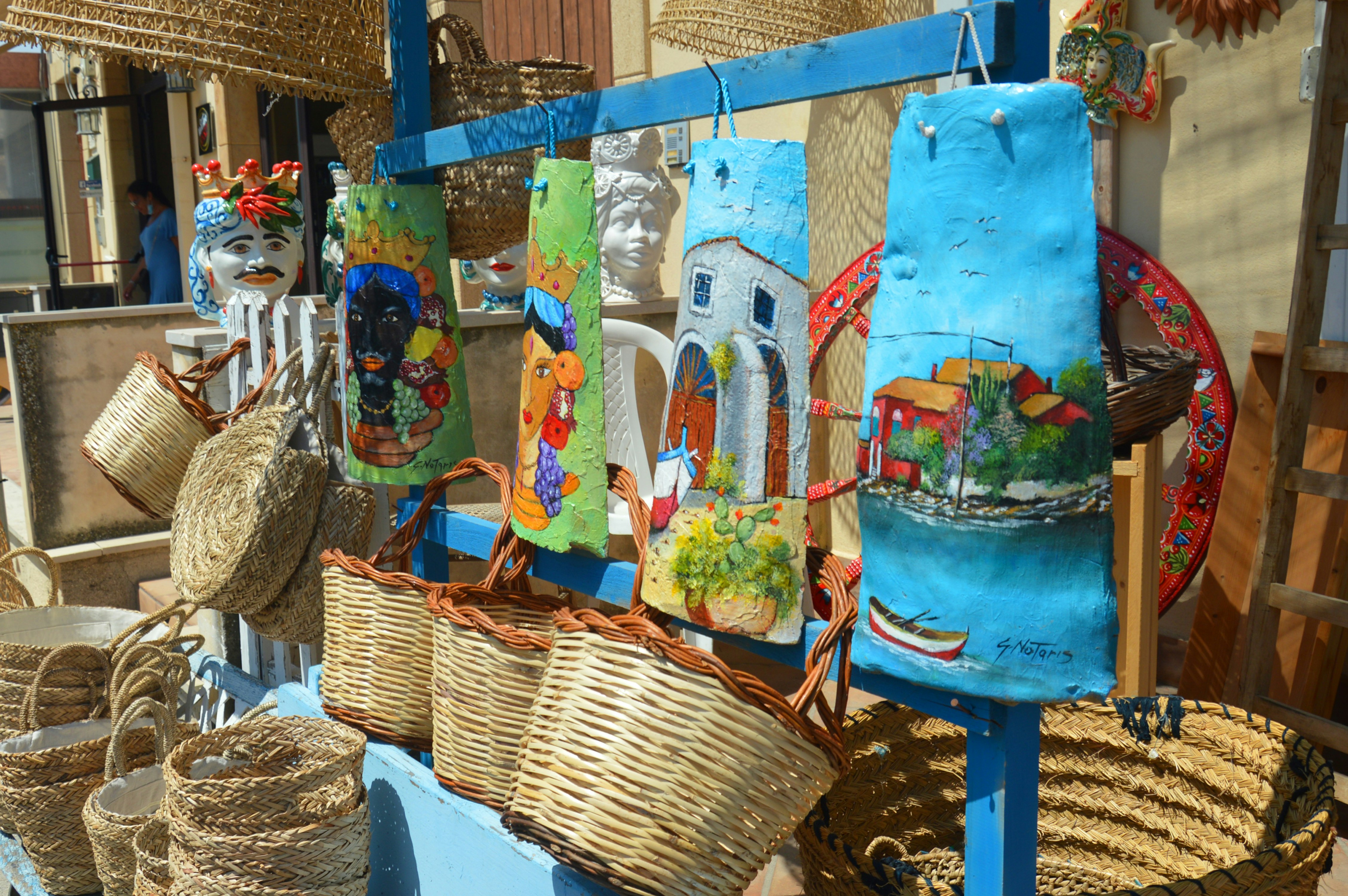 blue and yellow floral tote bag on blue plastic table, 