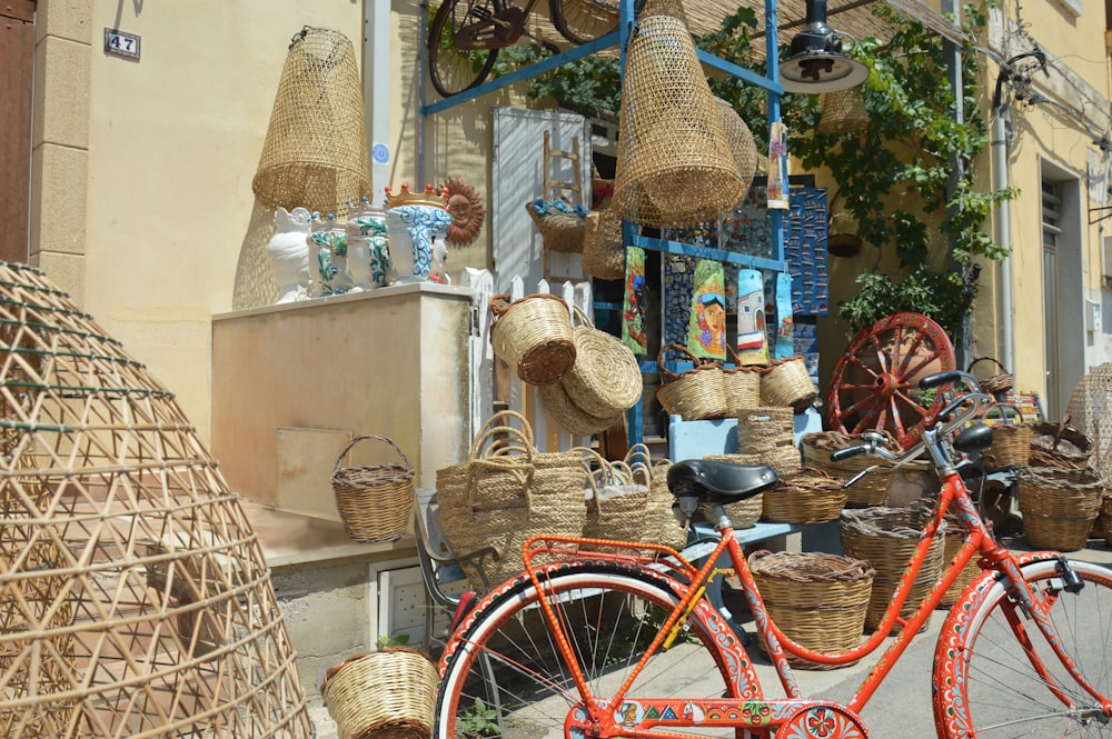 red bicycle parked beside brown wicker basket