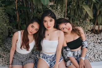 3 women in white and black floral tube dress