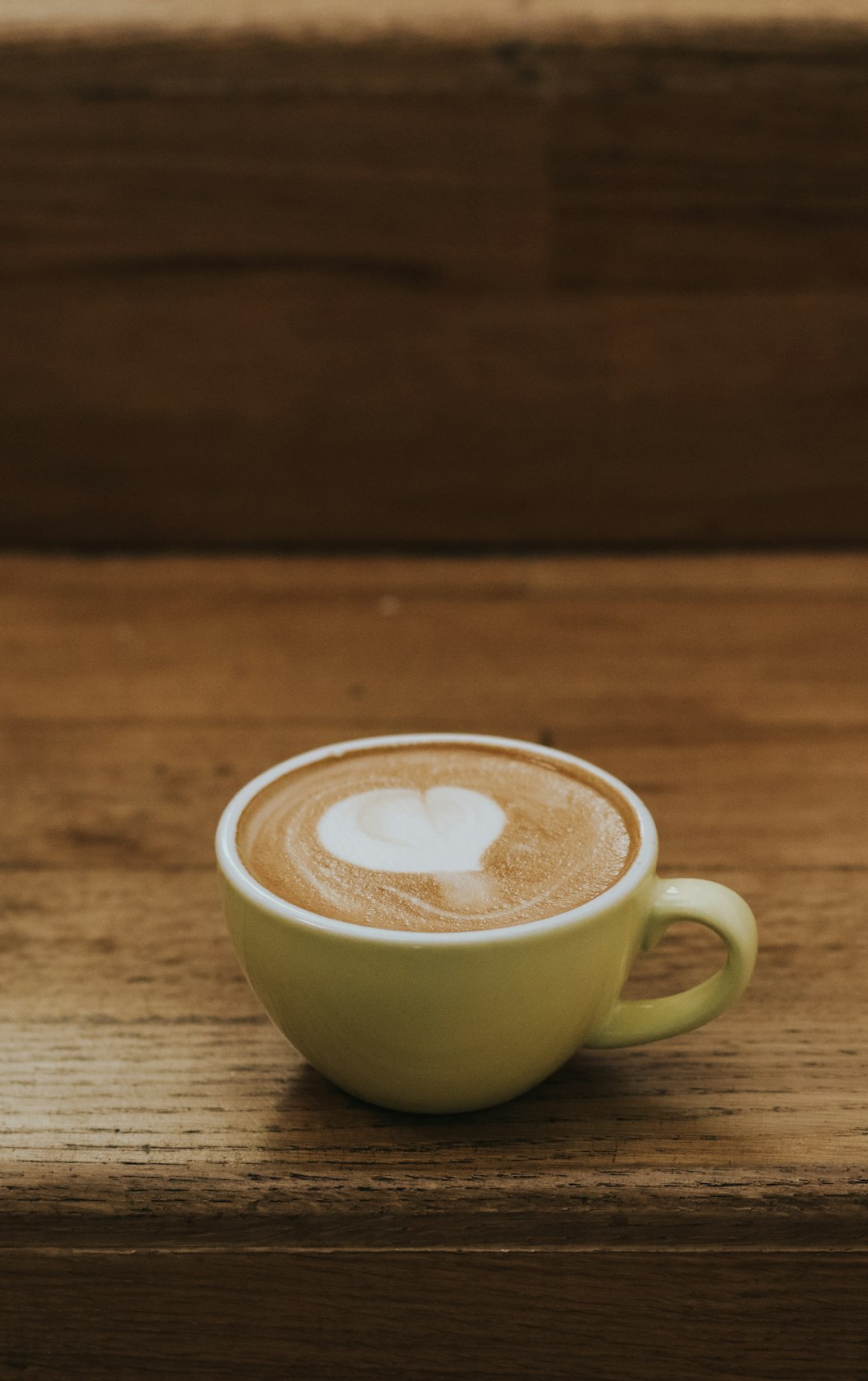 green ceramic mug with heart shaped coffee