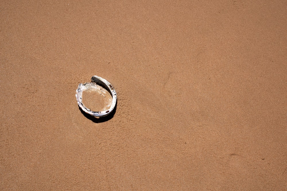 silver ring on brown sand