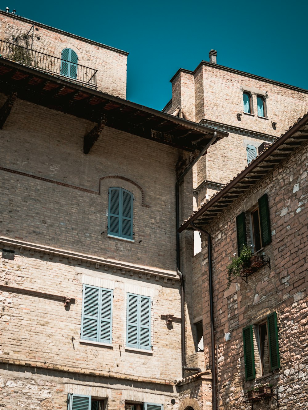 brown brick building with blue windows