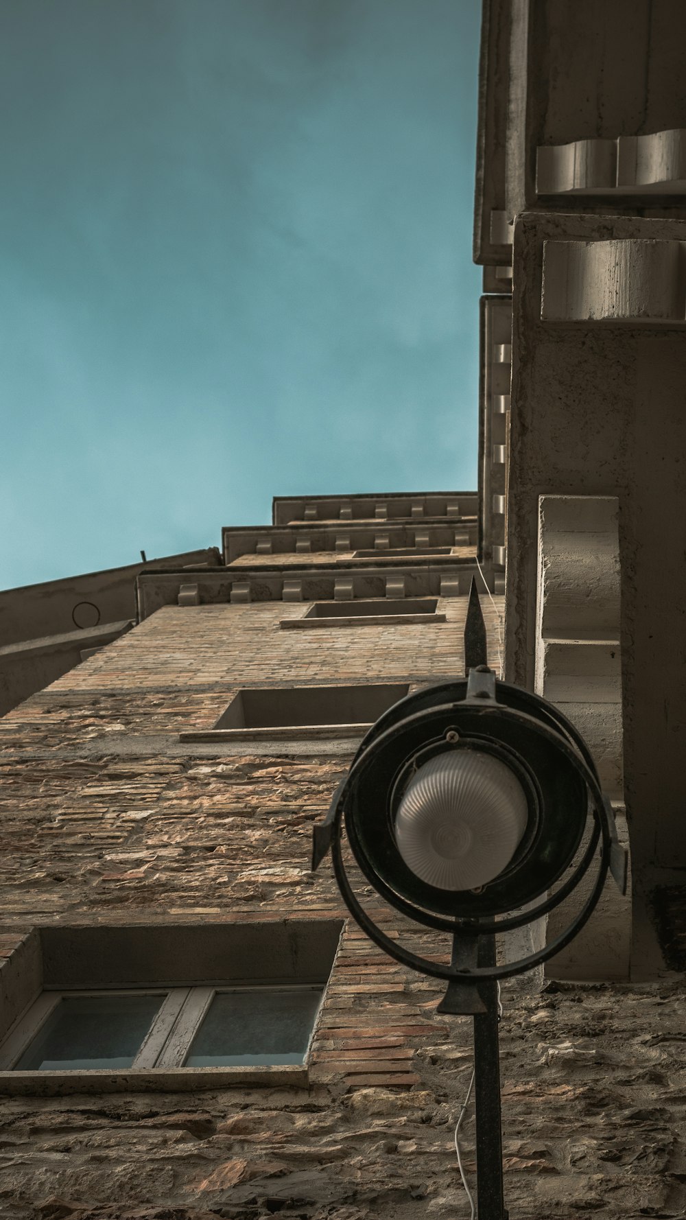 low angle photography of brown concrete building under blue sky during daytime