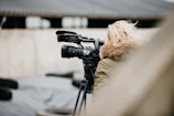 black camera on tripod in tilt shift lens