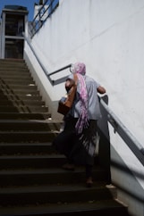 woman in black dress sitting on staircase
